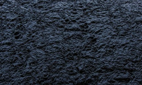 Natural stones and yoga accessories on a dark surface